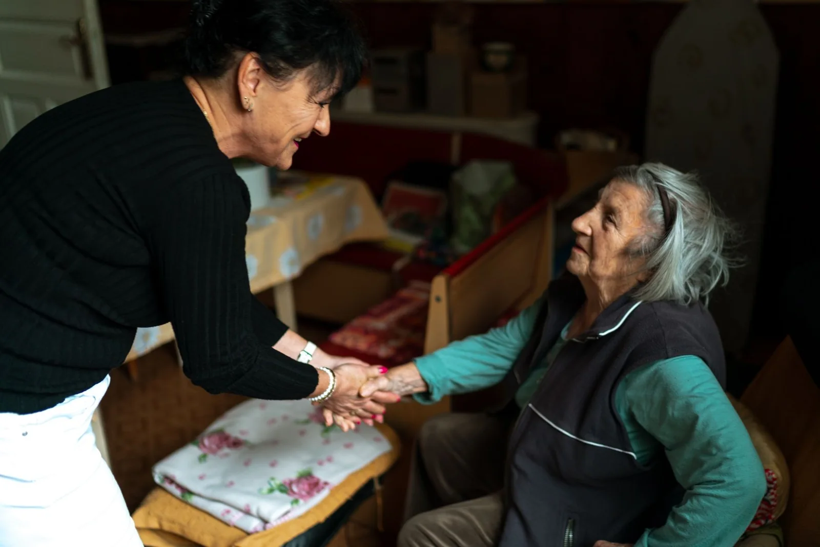 Two people sharing a warm, attentive conversation at home