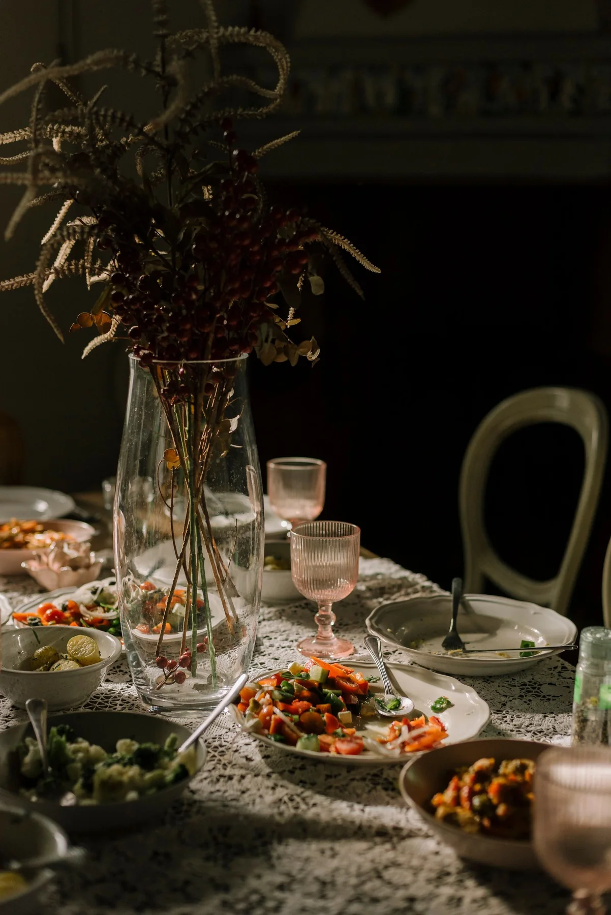 A thoughtfully laid dining table with flowers and seasonal food