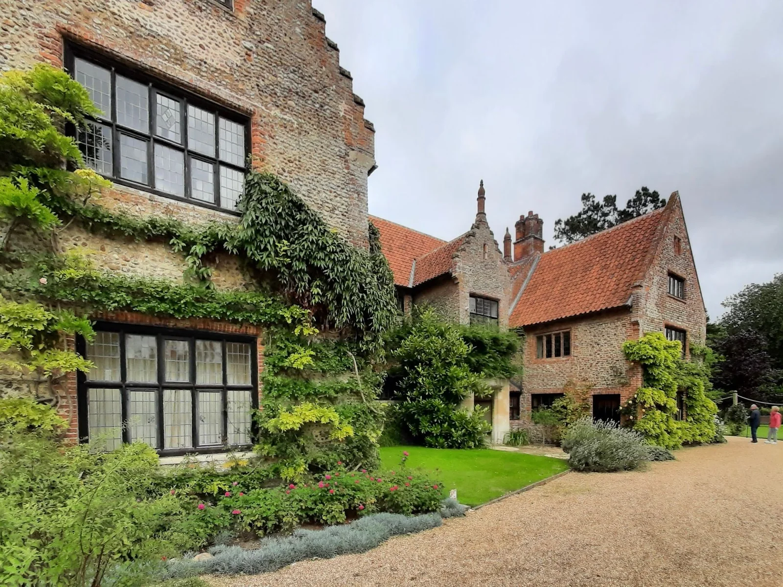 An ivy-covered country house beside a sheltered garden path